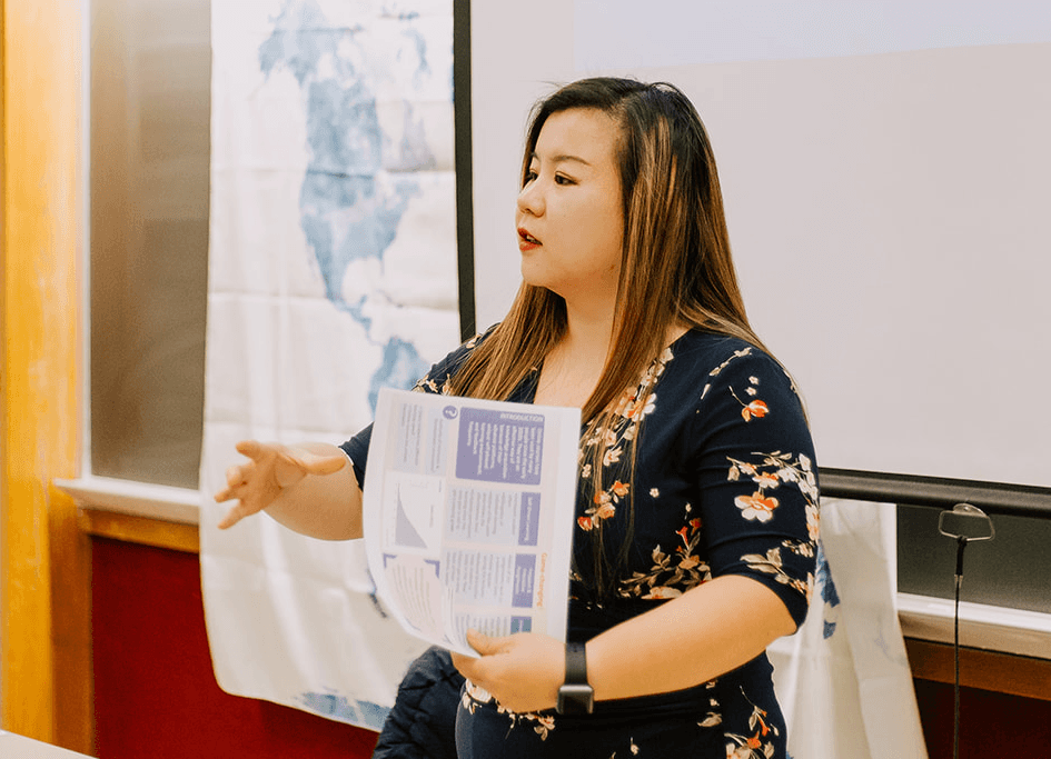 photo of instructor Fiona Wang giving a lecture in a classroom