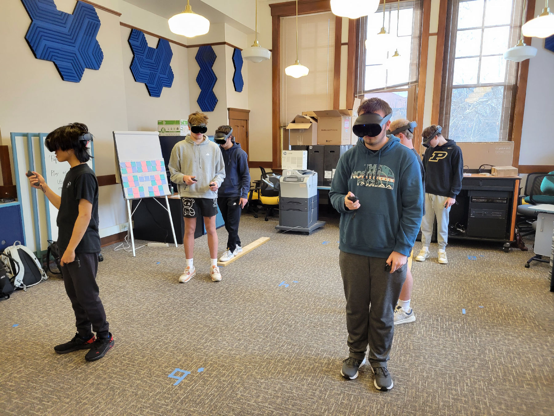 Students wearing VR headsets, standing in the lab.