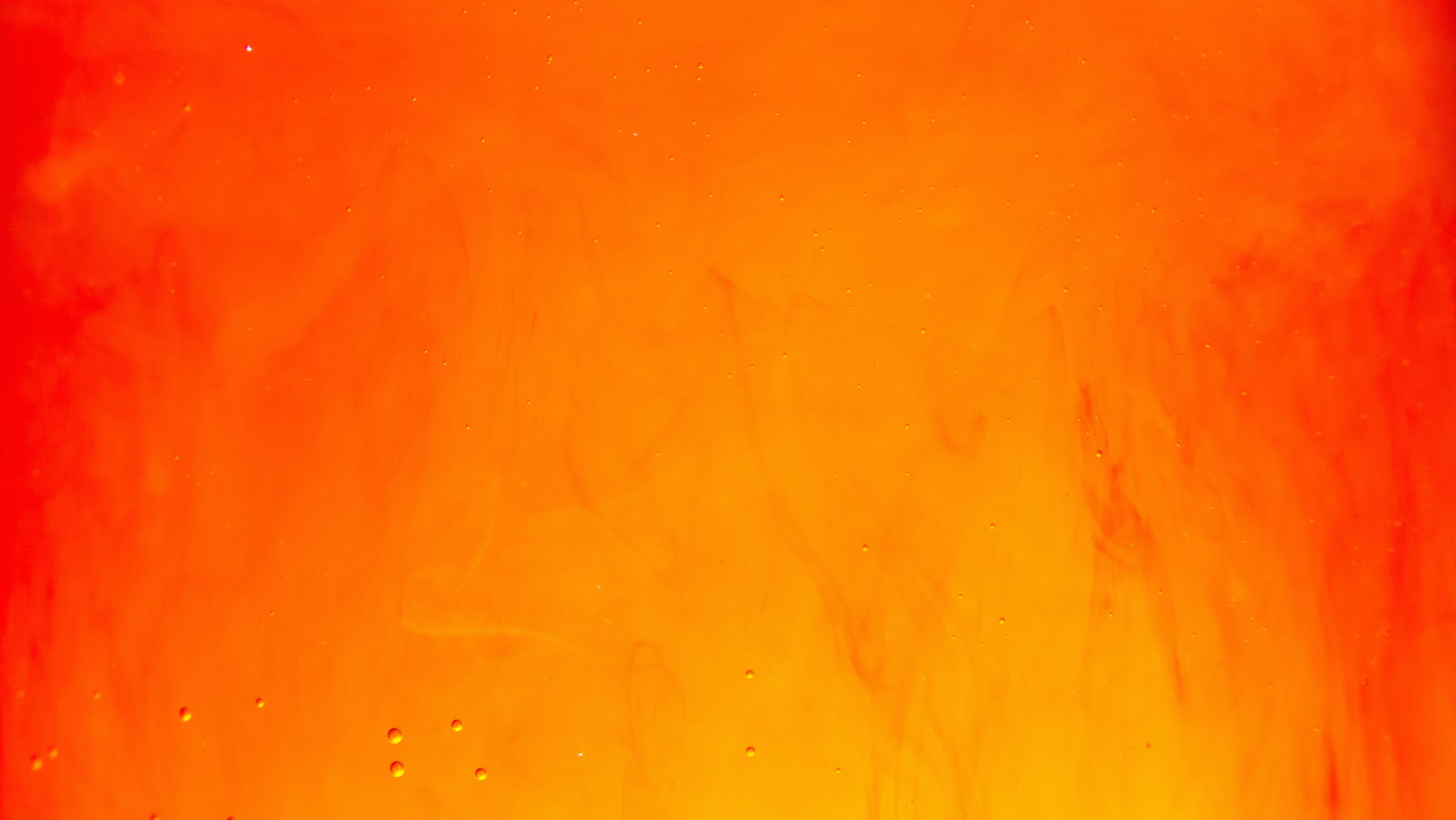 Orange, wavy fluid with bubbles.