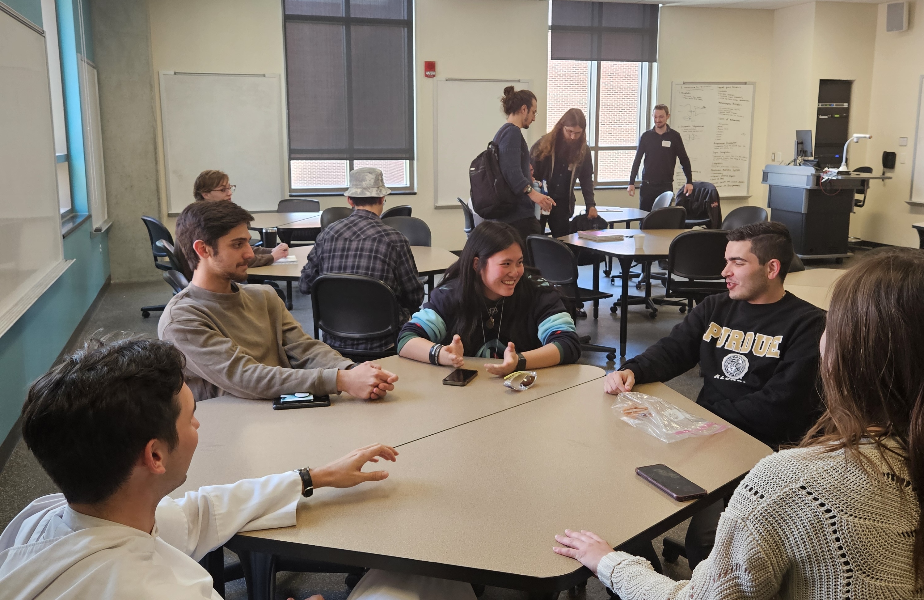Five undergraduate students sitting around a table.