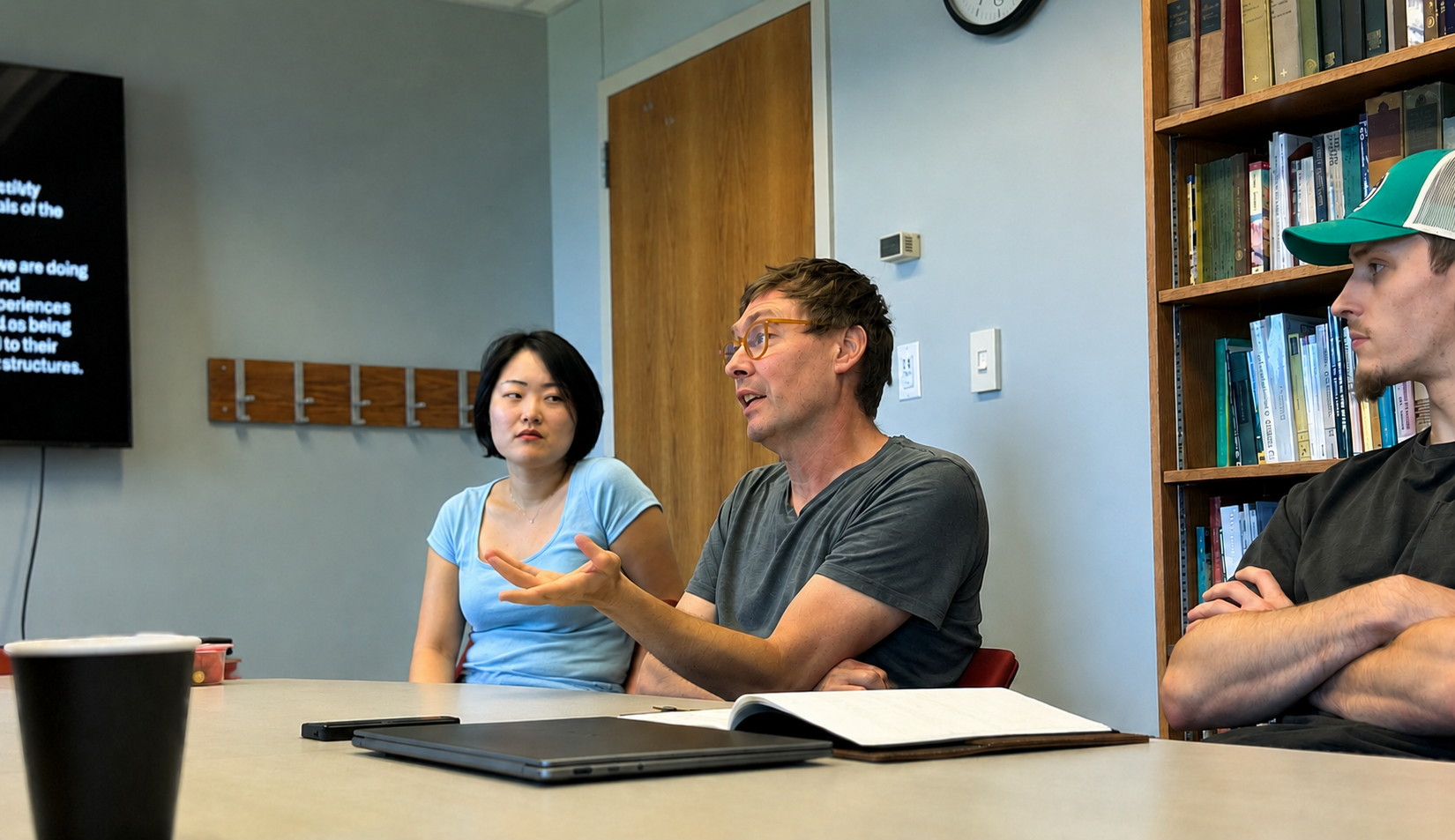 Students talking in a classroom.