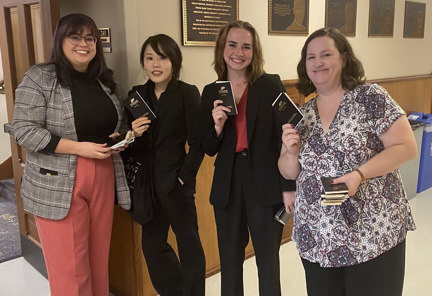 Four students handing out pocket Constitutions