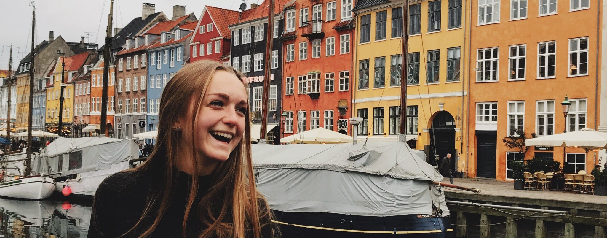 Student on colorful canal in Copenhagen