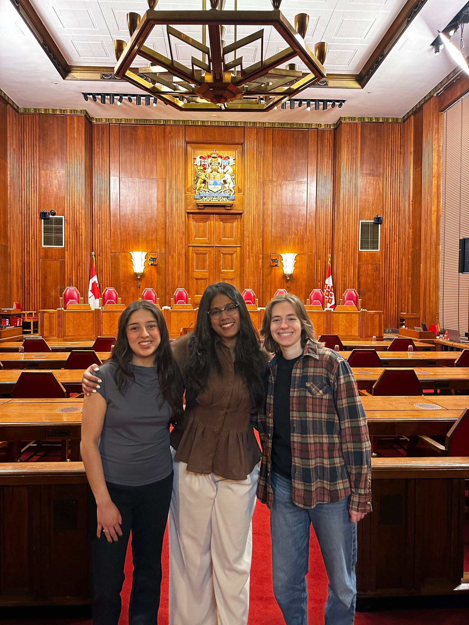 A photo of 3 students part of the export controls research group