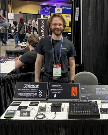 Trevor Marshall standing before his display of show control board system.