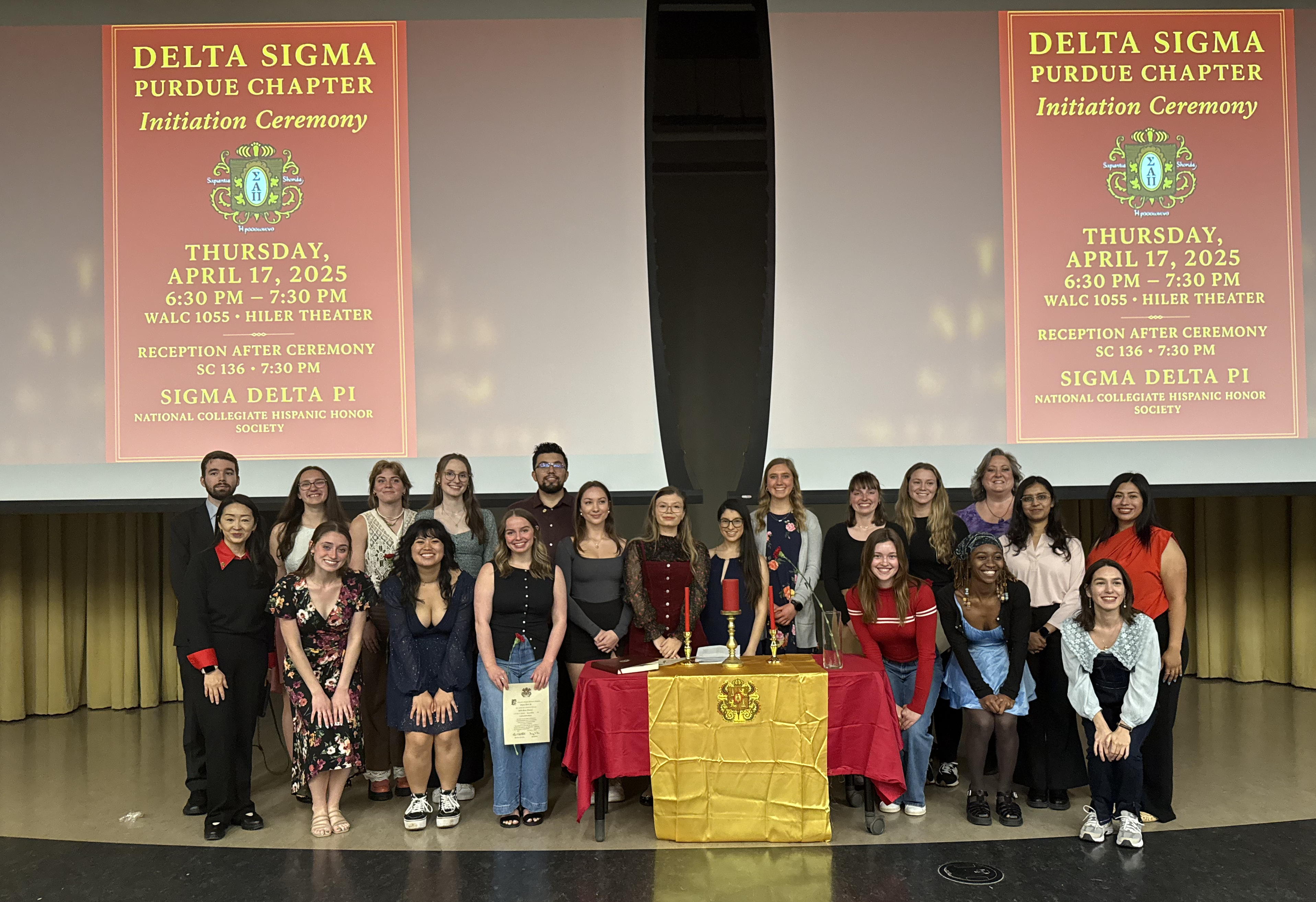 photo of many students that are part of delta sigma standing together and smiling with a 2025 powerpoint poster behind them 