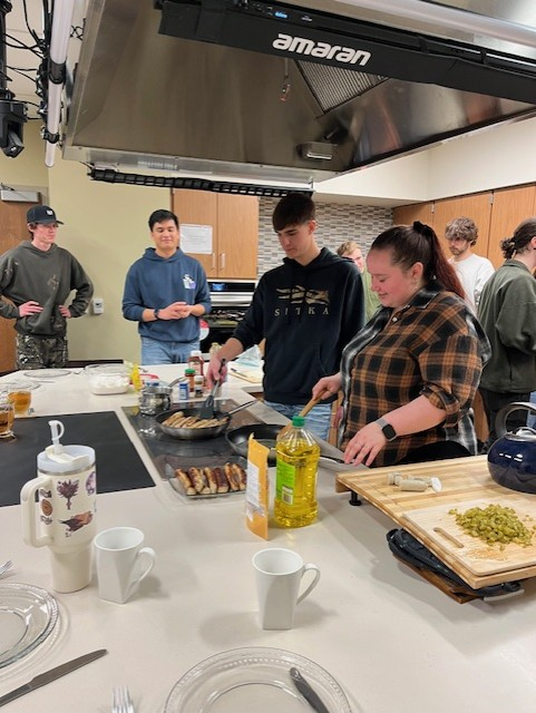 Student cooking Bratwurst in Cooking Lab Session