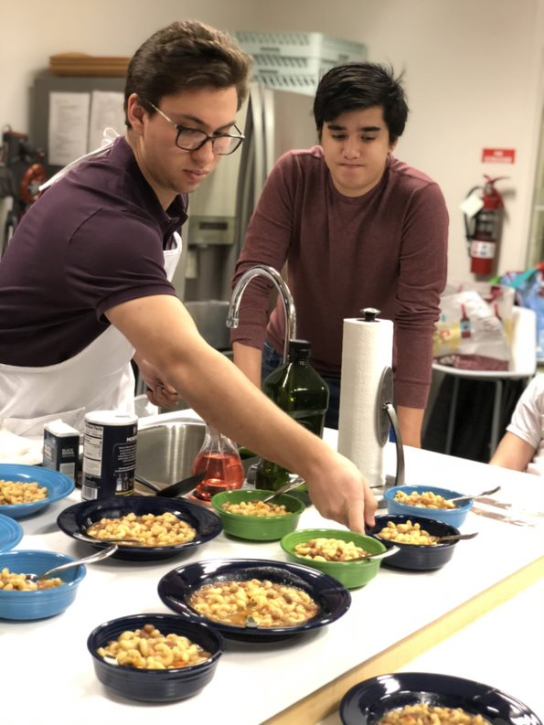 Student Serving Italian Food During Italian Foods and Cultures Lab class.