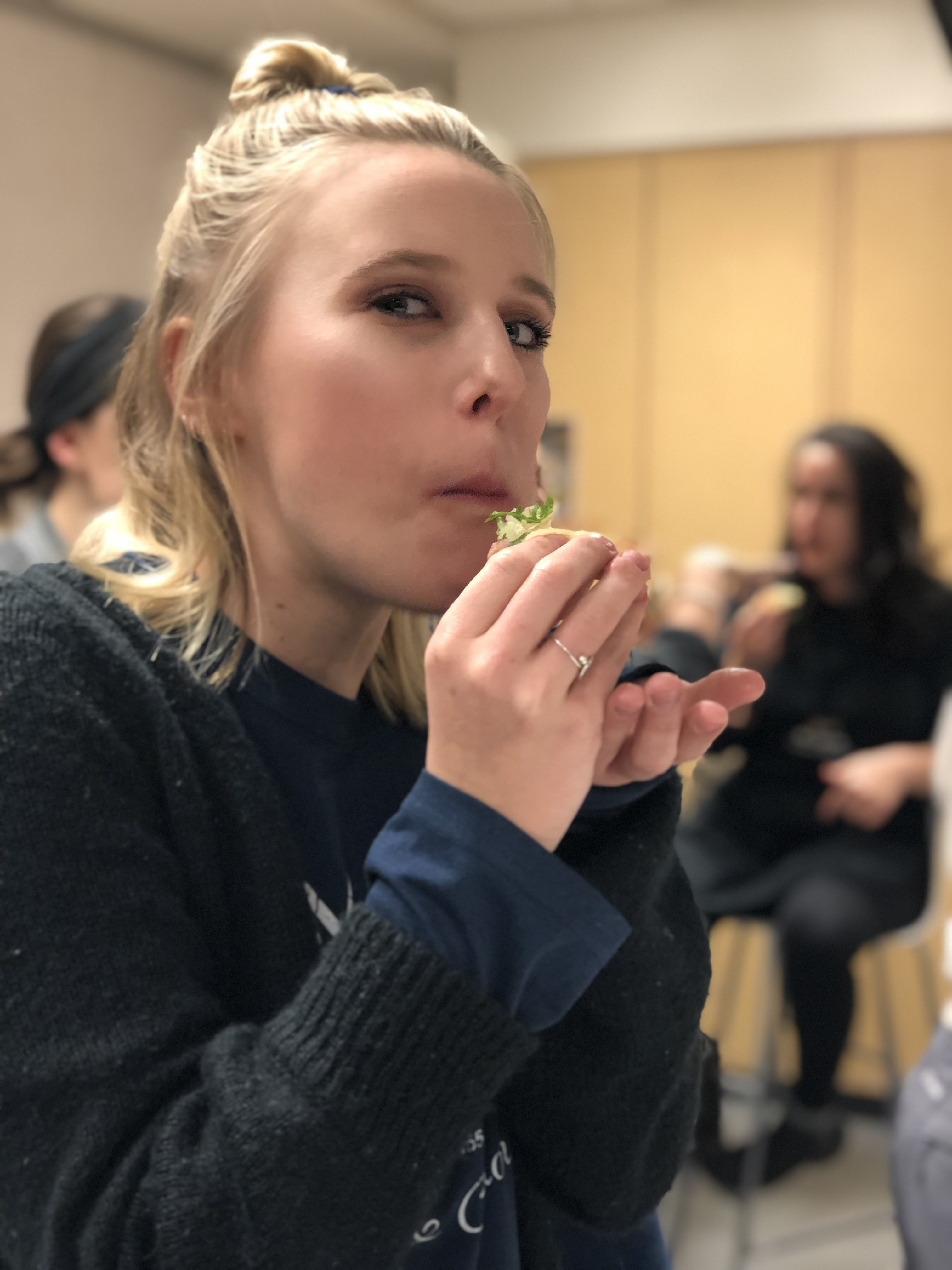 Student Sampling Food During a Cooking Class