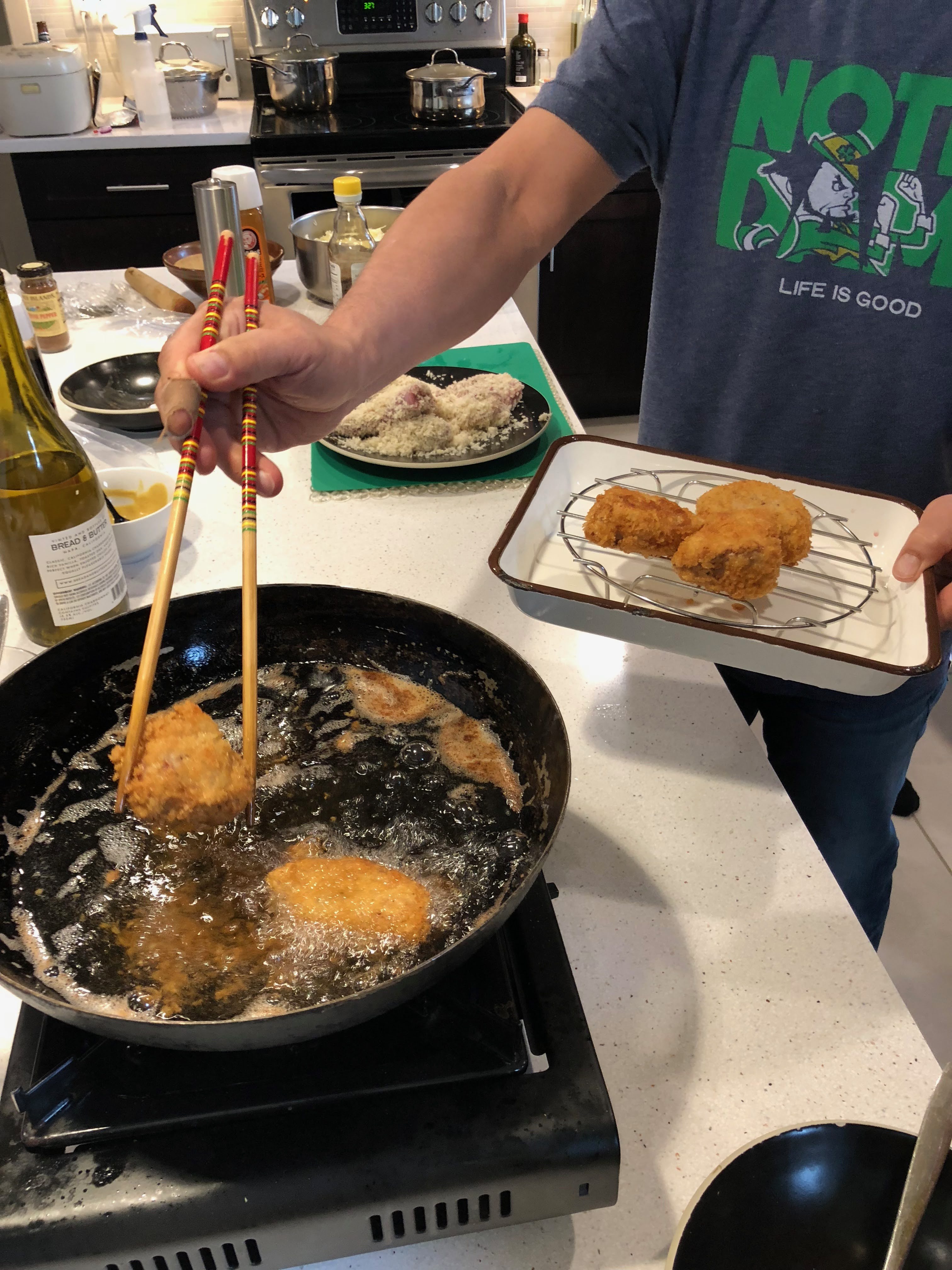 Student deep-Frying food in cooking lab