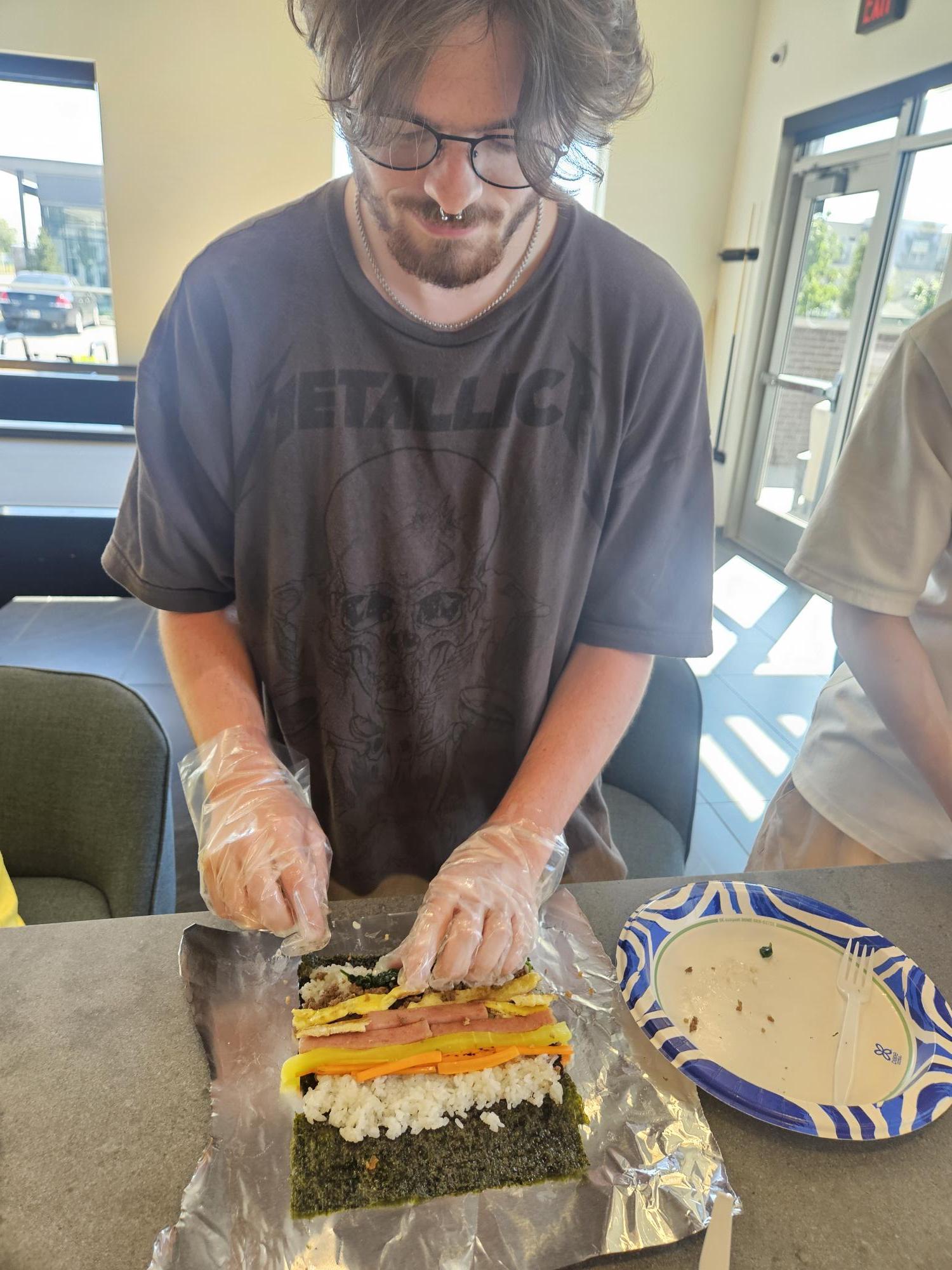 Student Preparing a Sushi Roll in a Teaching Kitchen