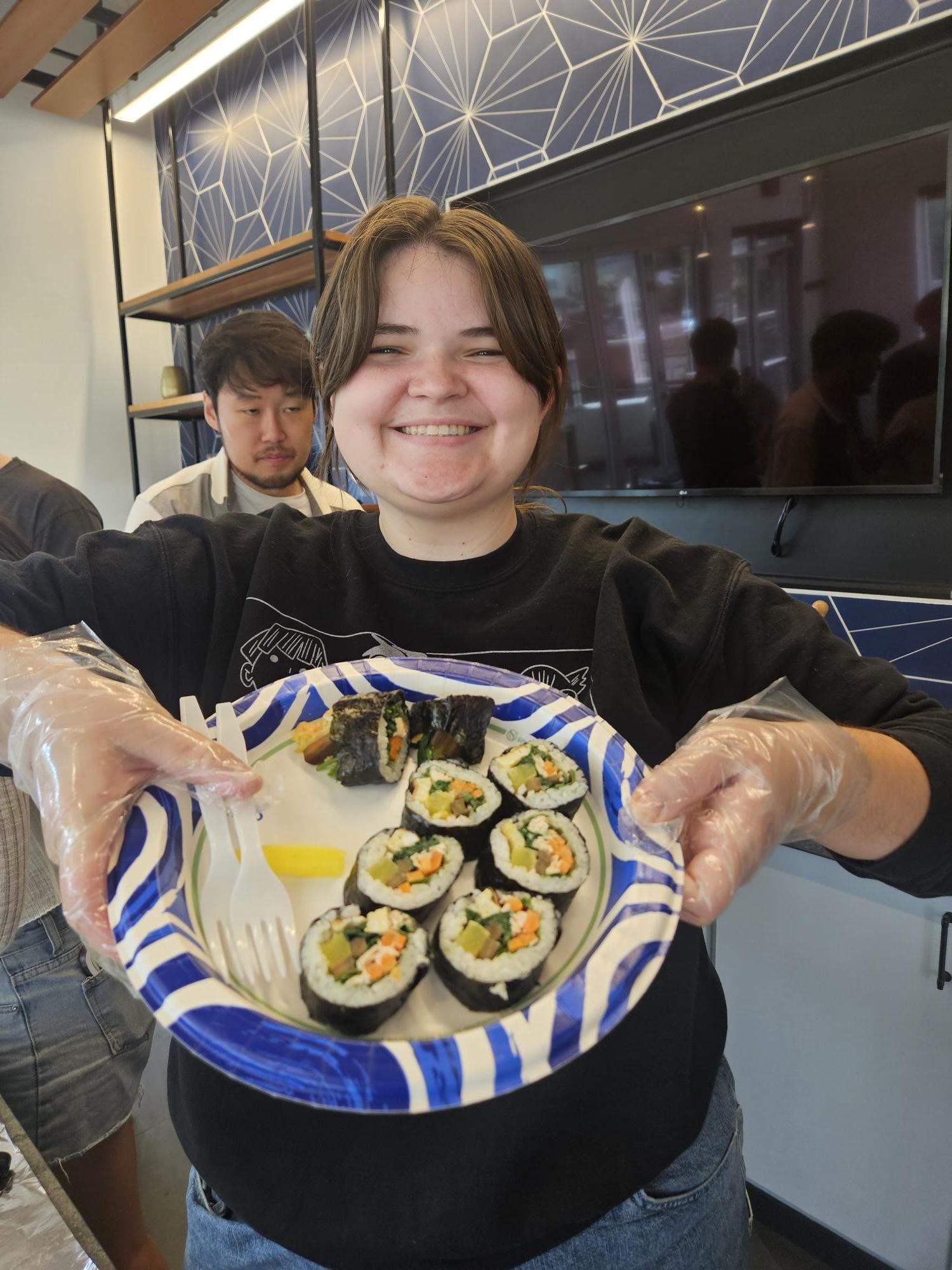 Student Showcasing Prepared Sushi Rolls