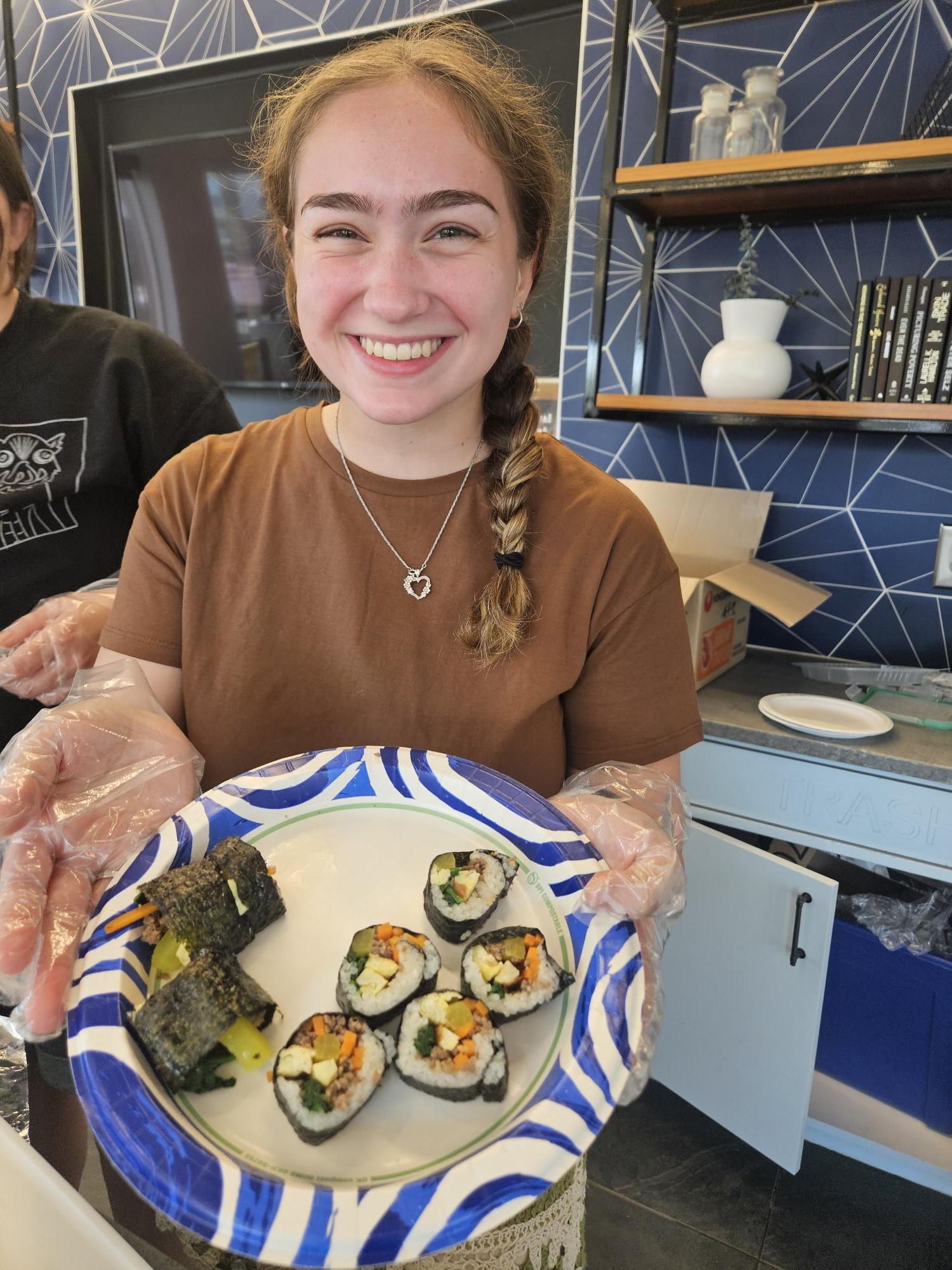 Student Showcasing Prepared Sushi Rolls