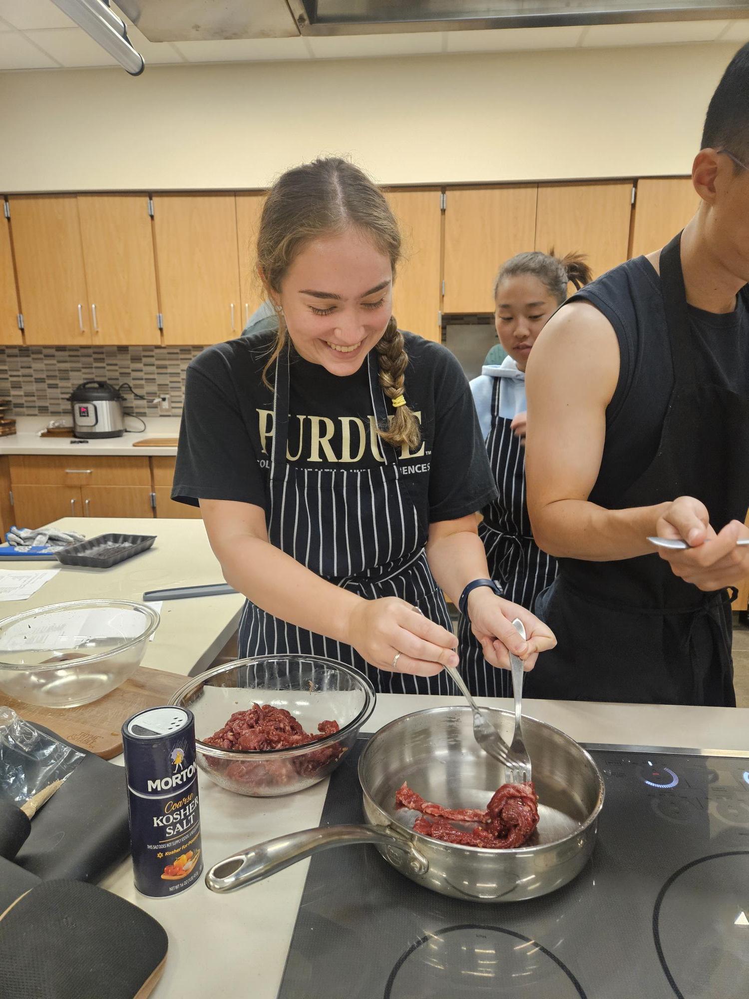 Students Practicing Cooking Techniques in a Kitchen Lab
