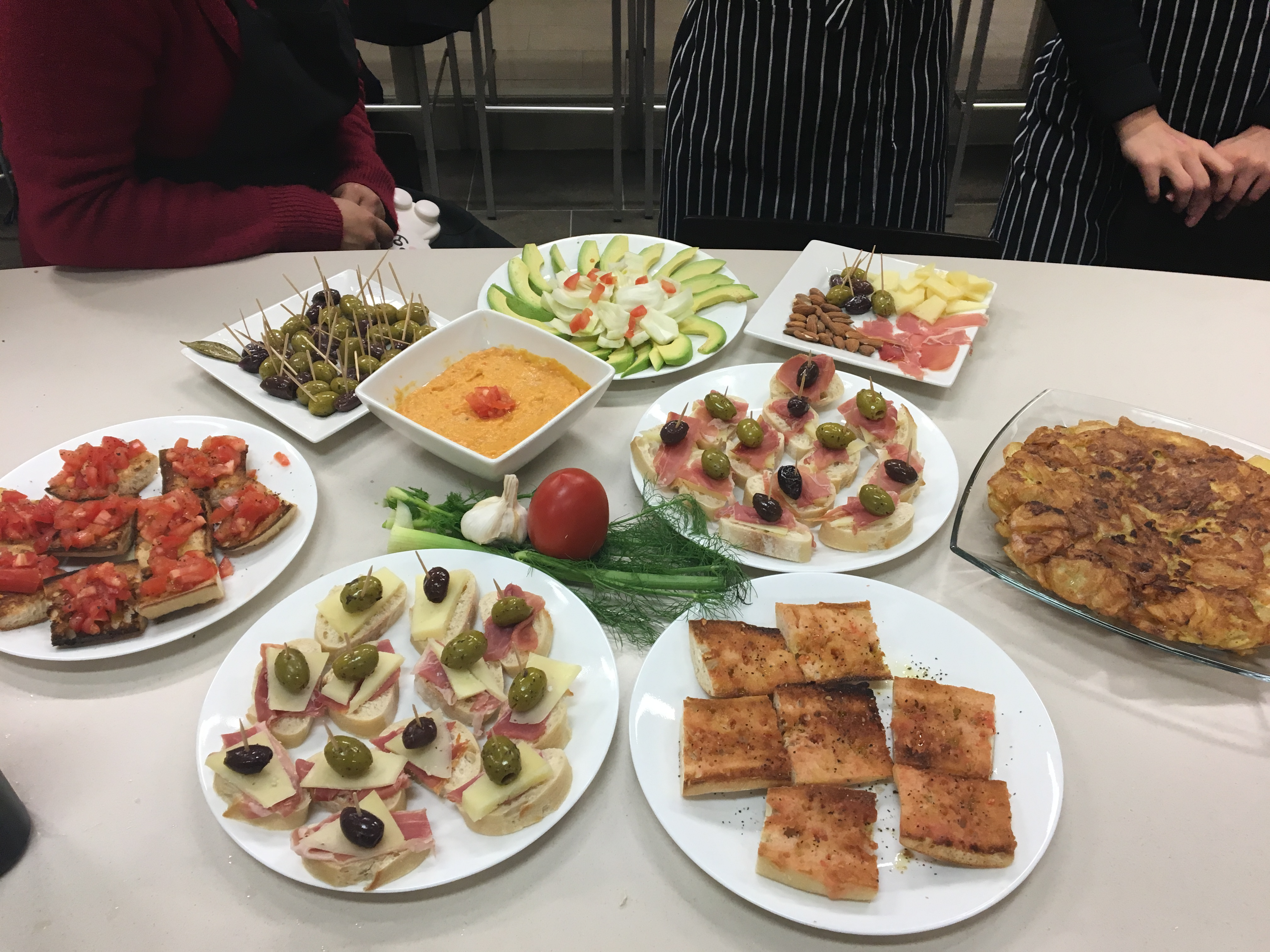 Table of Prepared Spanish Dishes Displayed for Tasting in a Cooking Class