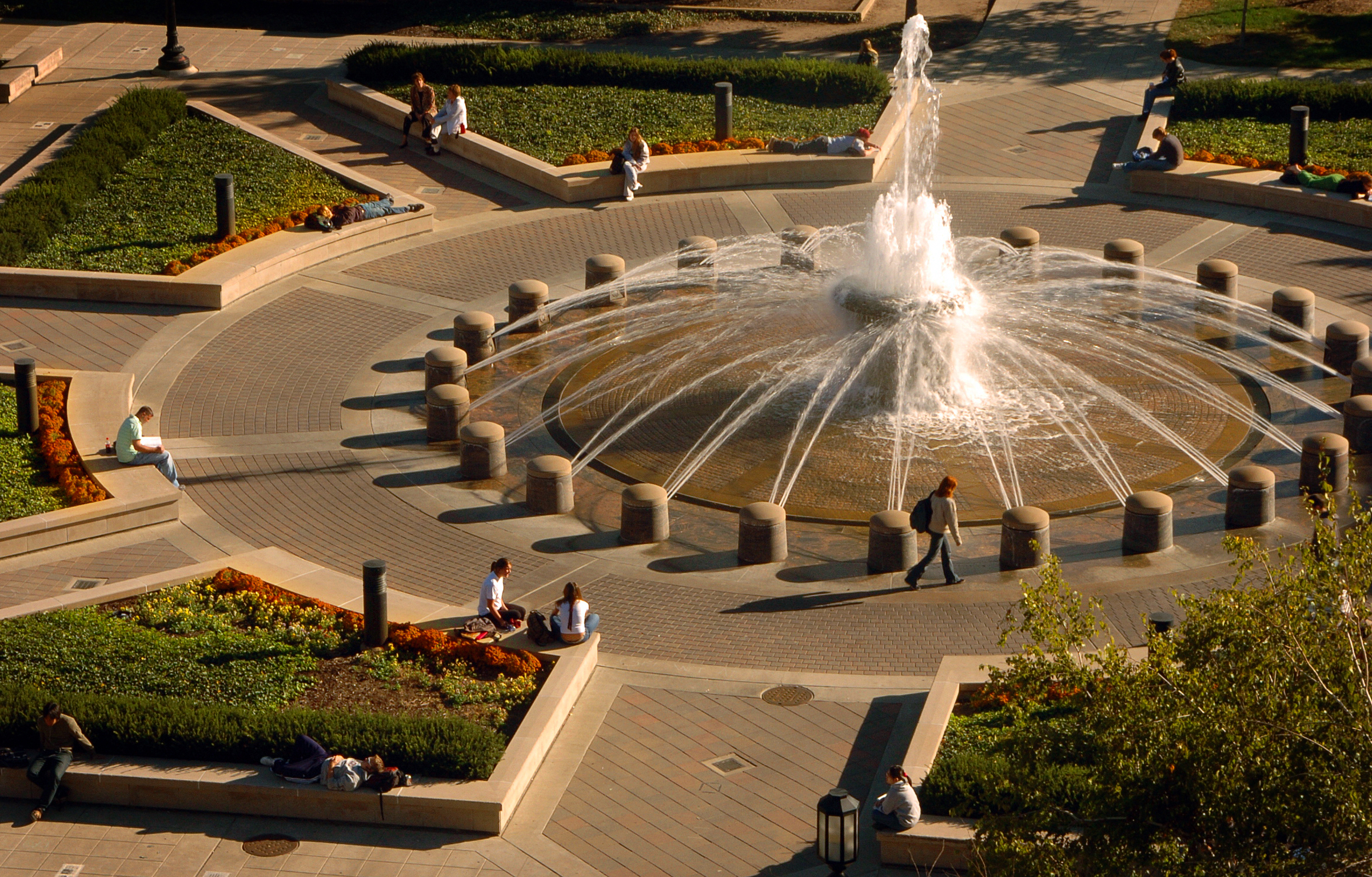 Viewed from Beering Hall of Liberal Arts and Education, students relax around Purdue's Founders Park fountain as fall brings shorter days, longer shadows and October light. Purdue's students will celebrate the season with October Break, a two-day respite from classes