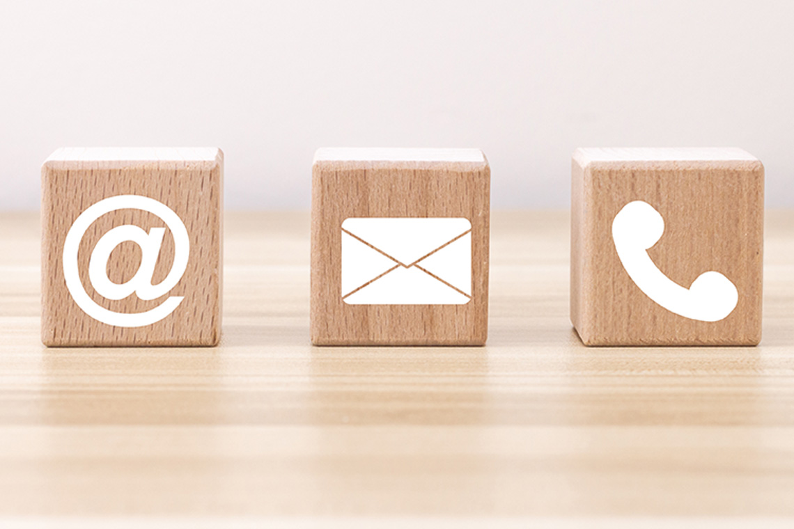Wooden blocks with icons representing various forms of contacting people