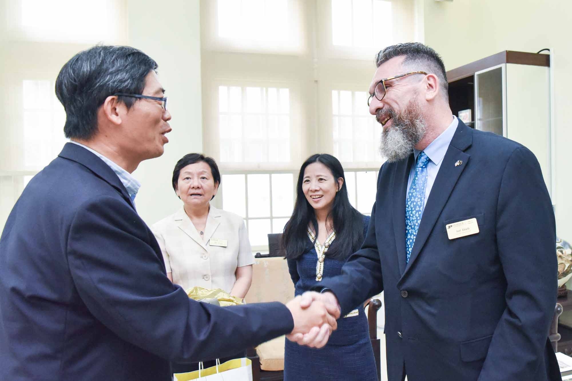 Previous CLA Associate Deans shaking hands with NTNU officials during Taiwan visit