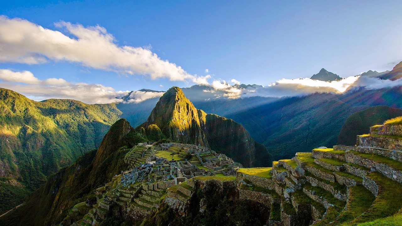 Sun descending on a mountain of ruins at Machu Picchu