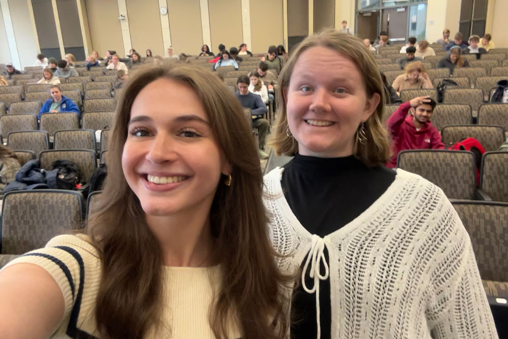 Teaching assistants Hannah Cano and Annmarie Pesavento pose in front of the classroom