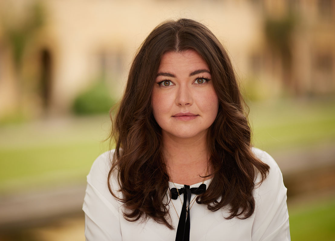 A headshot of Dr. Akimova against a blurred background.