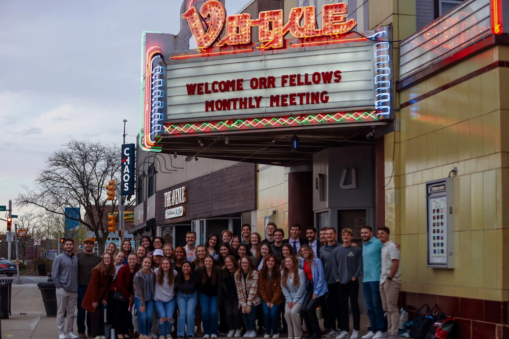 Orr Fellows recipients standing outside under the Vogue Theater marquee sign